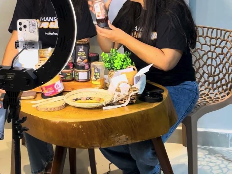 Products laid out on a live set, with a phone on a ring light